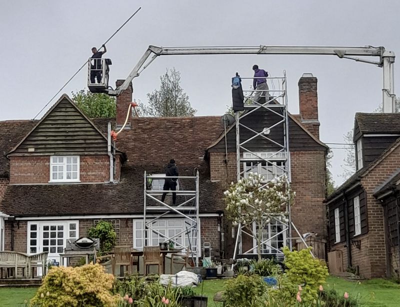 The Moss Cleaners using cherry picker and scaffolding to clean roof safely and professionally in Gloucester, Gloucestershire